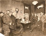 Office with nine men photo dated 1924 Newspaper Enterprise Assoc OM.jpg (50983 bytes)